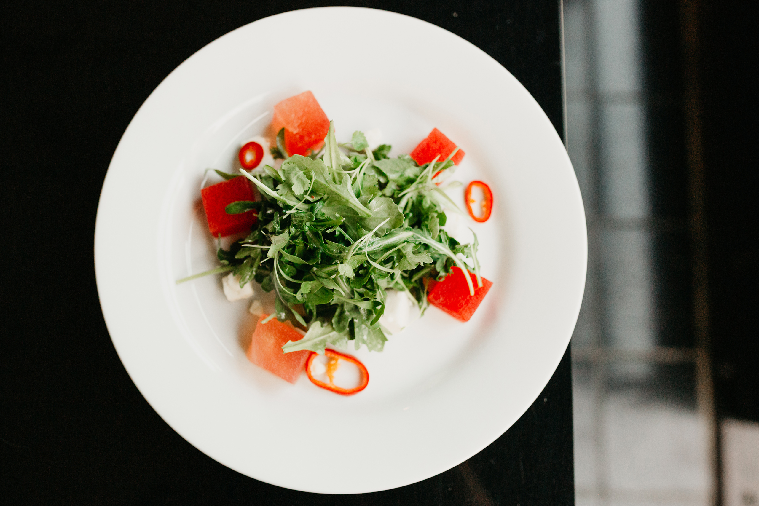 watermelon salad with arugula on white plate