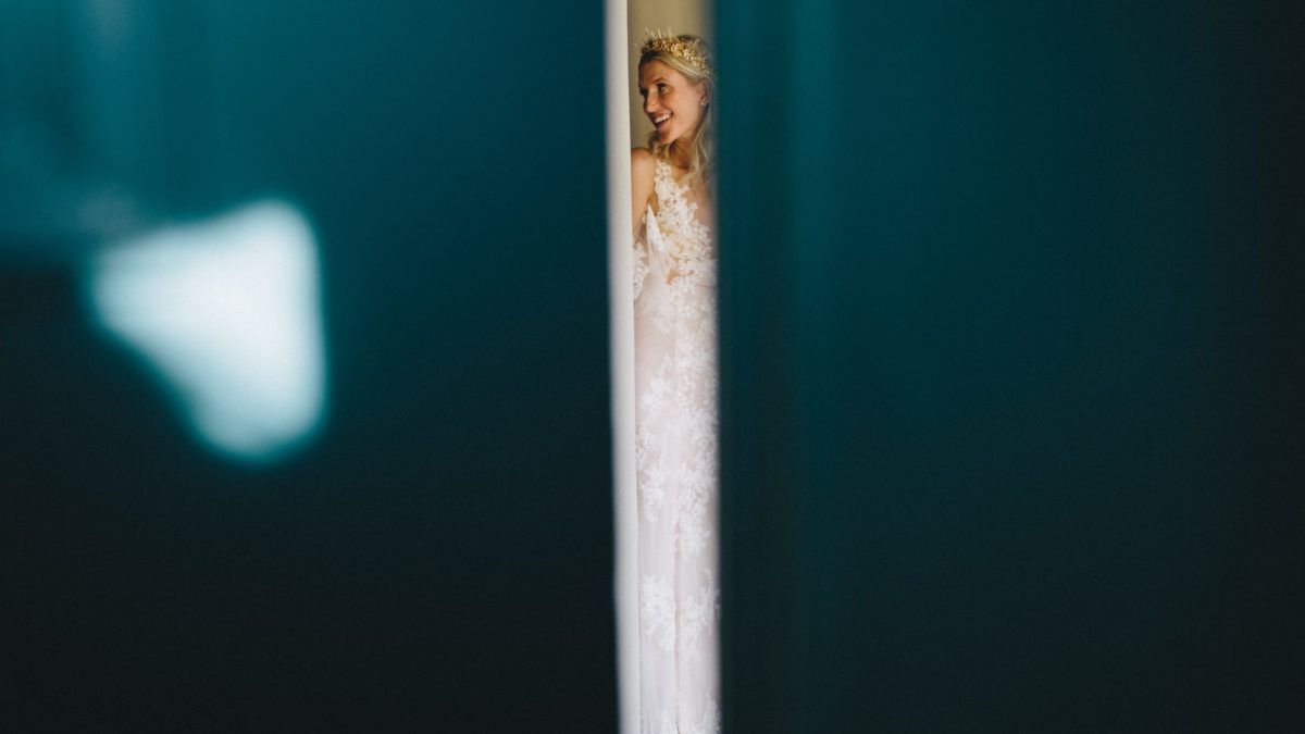 bride surrounded by teal walls
