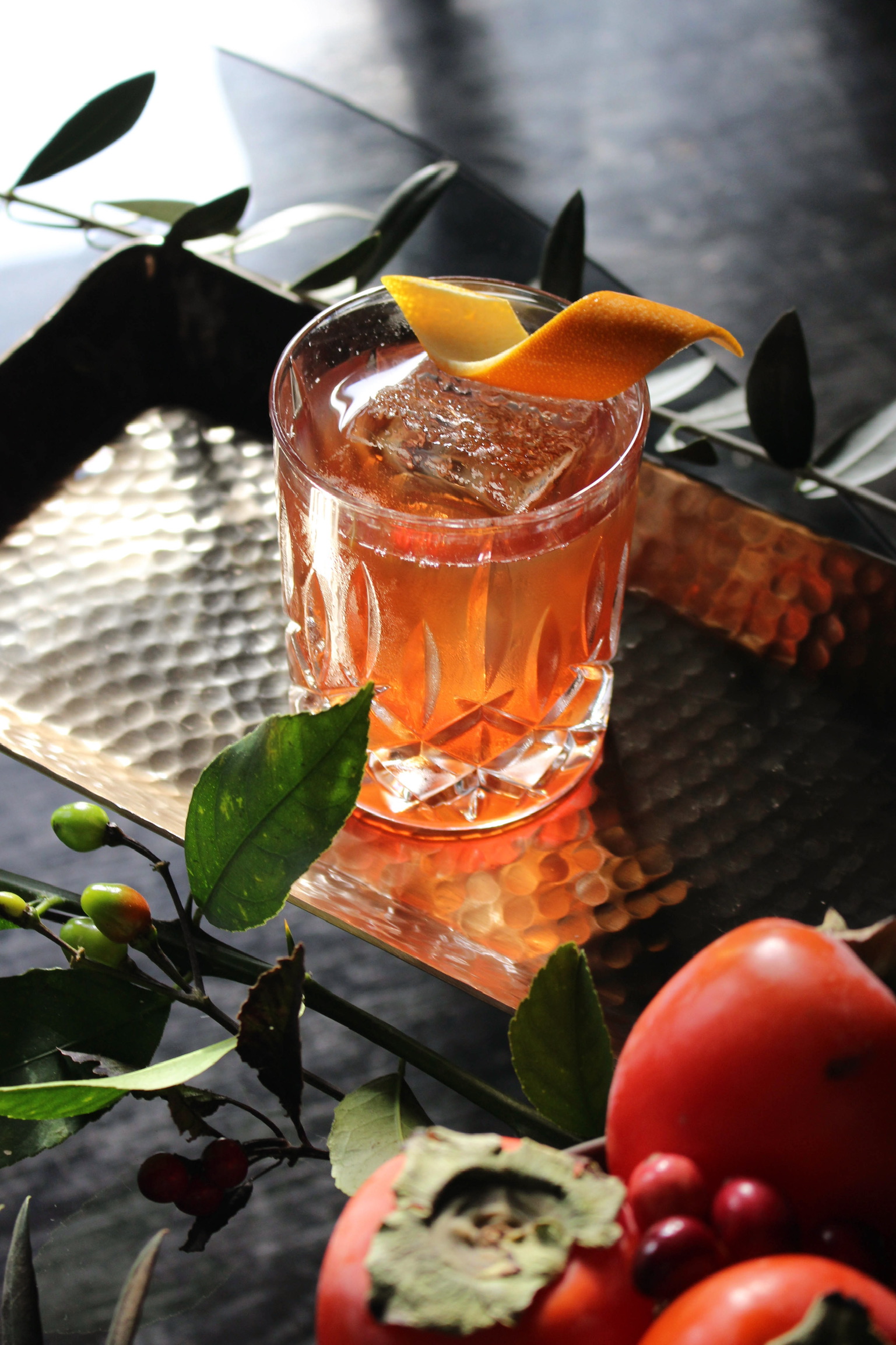 orange cocktail with orange garnish