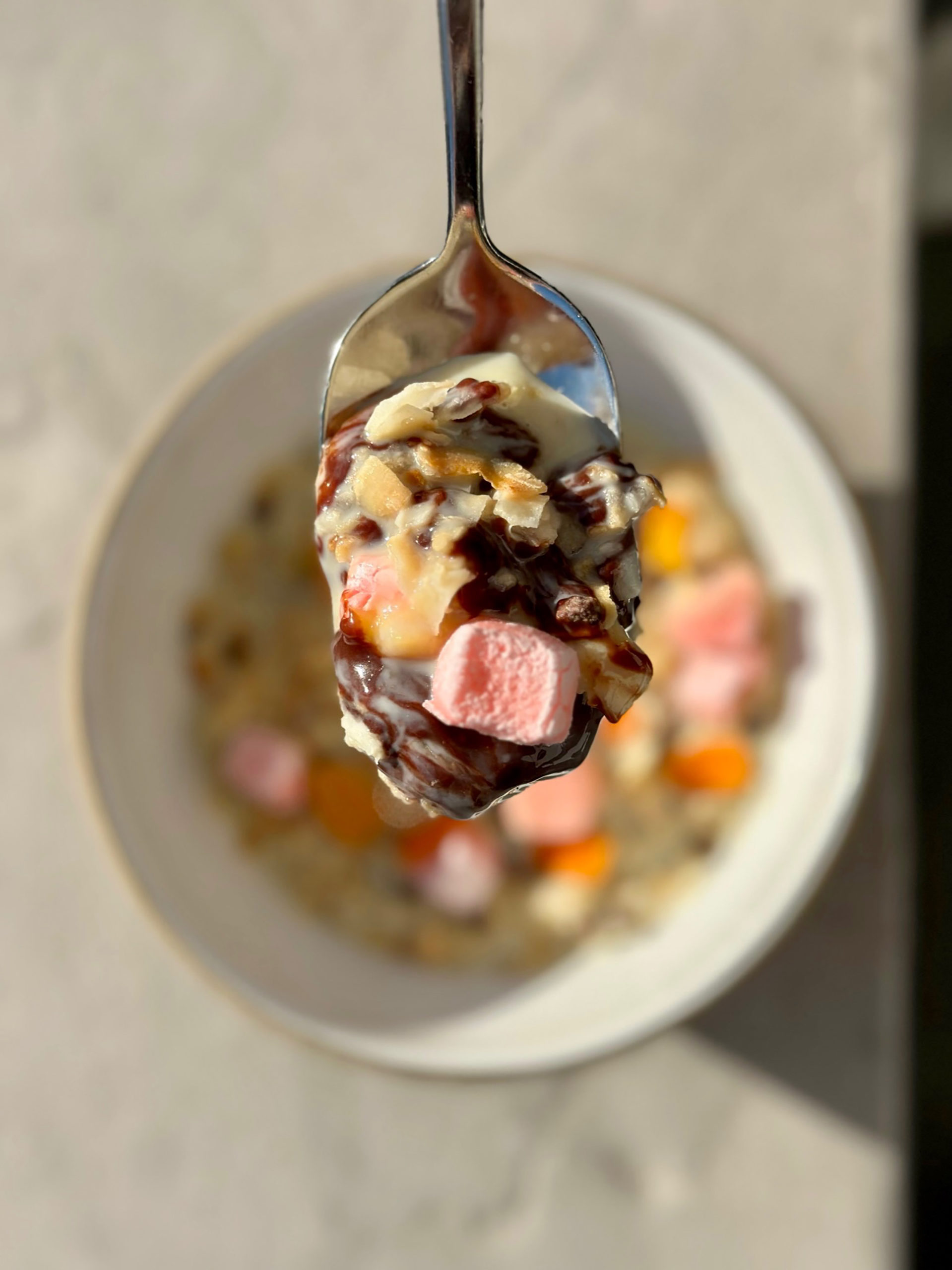 a scoop of pink and orange dessert on a spoon