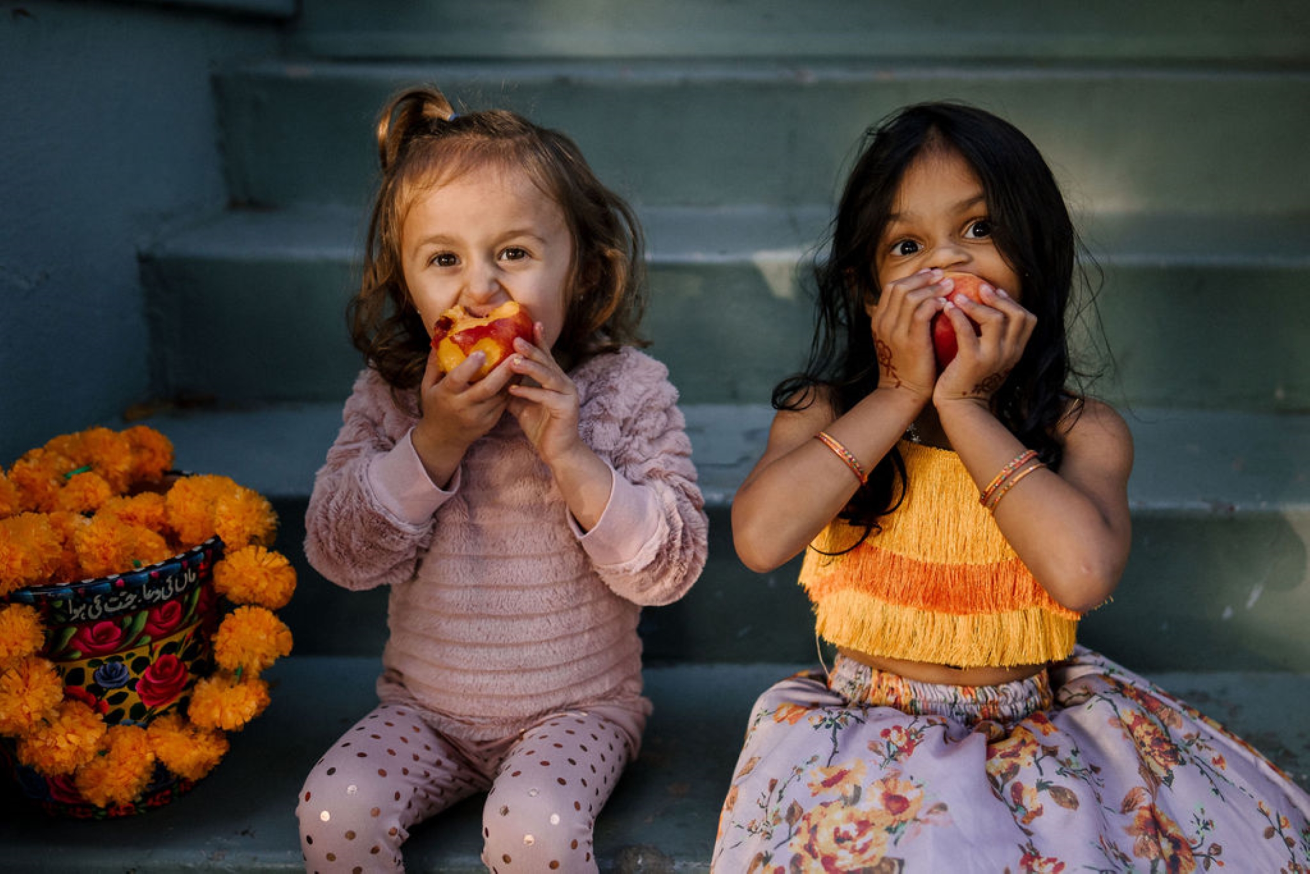 flower girls eating peaches