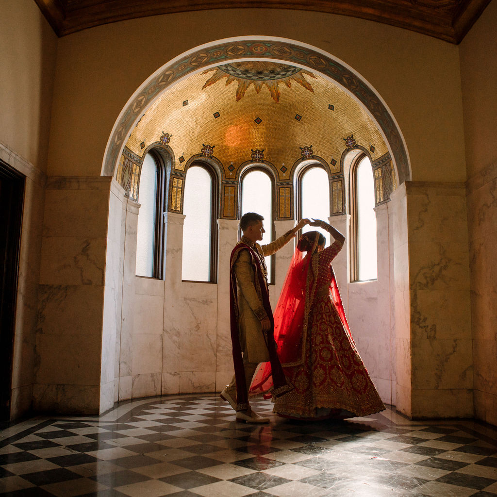 bride and groom dancing in front of vibiana vestibule