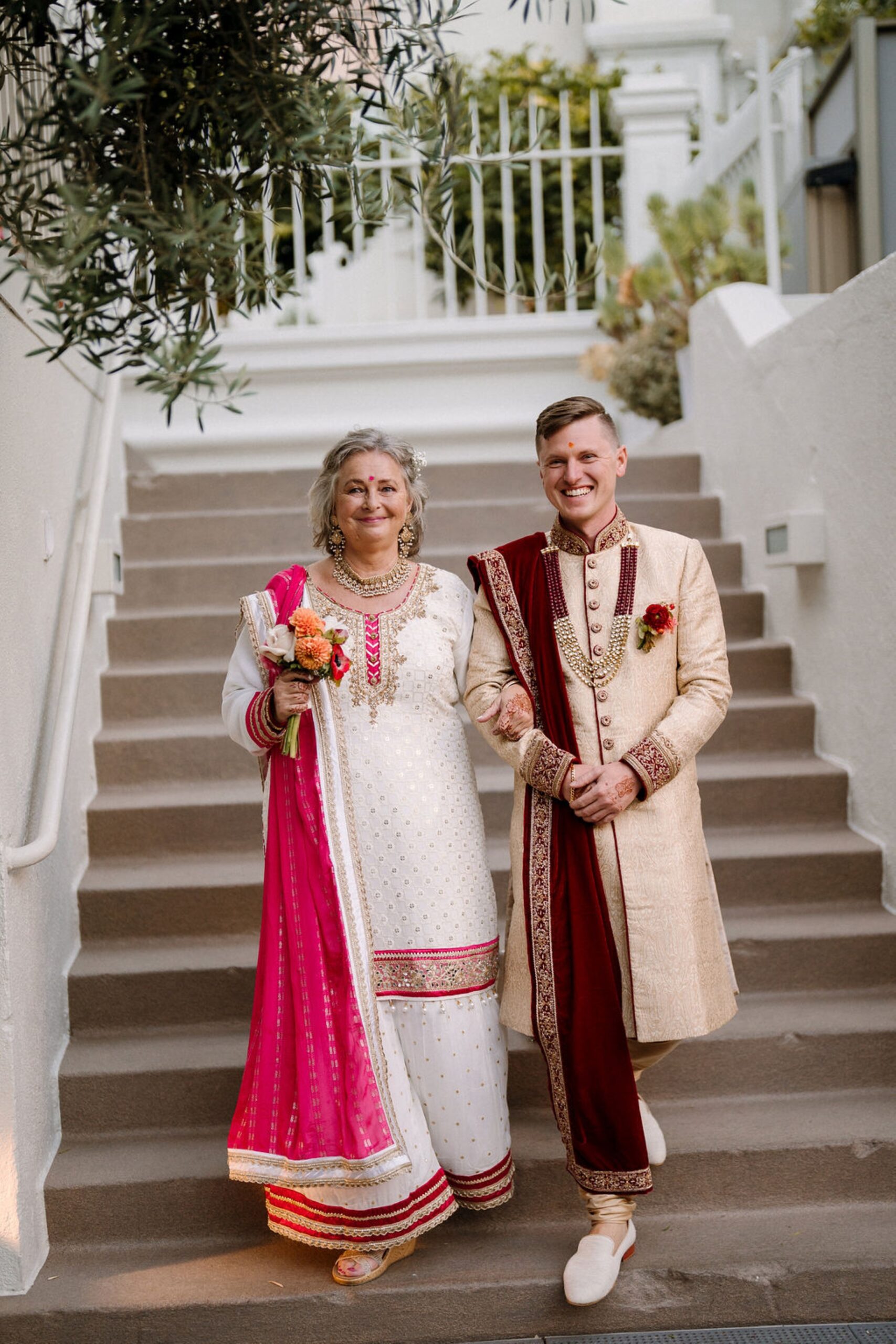 mother and son walking down stairs for wedding ceremony
