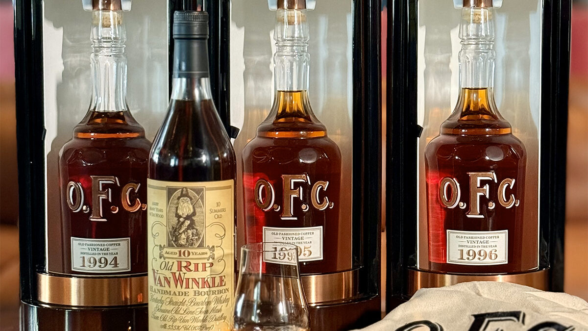 vintage bourbon bottles set out on a table with a glen cairn glass